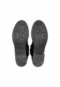 Chaussures noires avec une semelle en caoutchouc texturé présentant un motif d'étoile et de cheval. Le dessous comprend un profil pour la traction et l'adhérence.