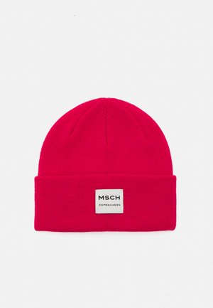 Pink knitted beanie with a cuff and a square label that reads "MSCH COPENHAGEN." Features a smooth texture and a rounded top.