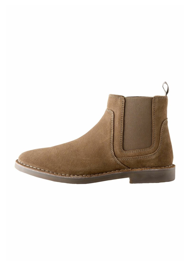 Brown suede ankle boot with elastic side panels, round toe, and a loop handle at the back; stitched detailing along the sole.