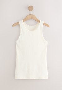 White ribbed sleeveless tank top hanging on a light wooden hanger against a plain pale background.