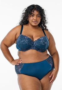 Navy blue bra and panties set featuring floral lace accents in lavender. The bra has structured cups and adjustable straps; underwear has lace trim.