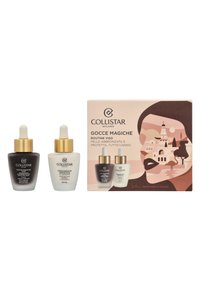 Collistar Gocce Magiche set with two dropper bottles: one dark brown, one white; both with gold accents; boxed in illustrated packaging.
