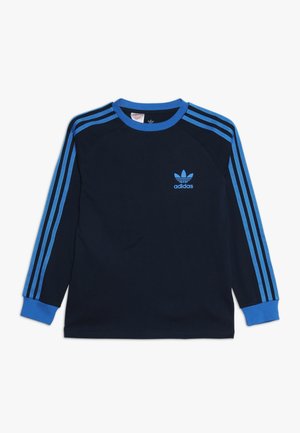 Sweat-shirt à manches longues bleu marine avec col et poignets côtelés bleus, comportant trois bandes bleues le long de chaque bras et un petit logo Adidas bleu sur la poitrine.