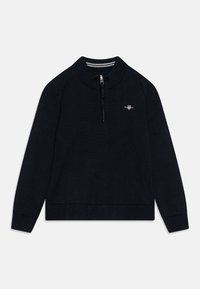 Laika sininen vetoketjullinen neule, jossa on pitkät hihat, ribbireunus ja -hihansuut, sekä pieni brodeerattu logo rinnassa. Pehmeä neulemateriaali.
