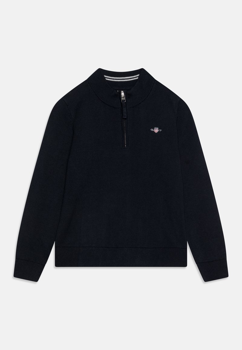 Sweater de cuello con cremallera en color azul marino, con mangas largas, dobladillo y puños acanalados, que presenta un pequeño logo bordado en el pecho. Material de punto suave.