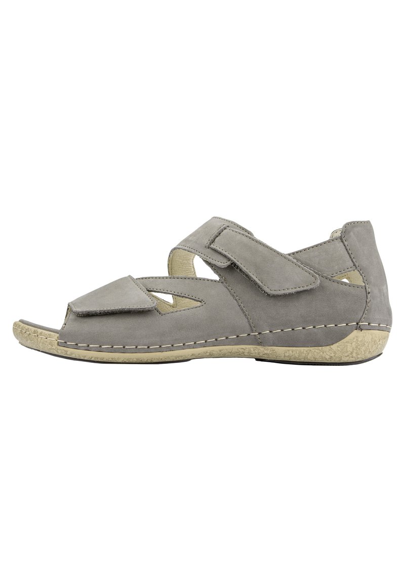 Grey suede sandal with open toe, velcro straps, and cut-out design. Rubber sole with textured detailing along the edge.