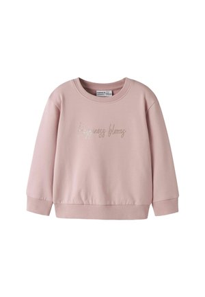 Sweat-shirt enfant rose clair à manches longues avec poignets et ourlet côtelés, et texte "Happiness blooms" en écriture pailletée sur le devant.