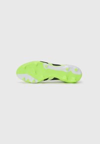 Black soccer cleat featuring a textured upper, bright green rubber outsole with studs, and white accents on the heel and outsole areas.