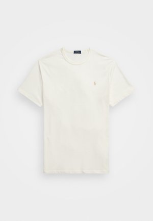Tricou cu mânecă scurtă, de culoare albă murdară, din bumbac. Dispune de un mic logo brodat de culoare bej pe partea stângă a pieptului. Textură netedă.