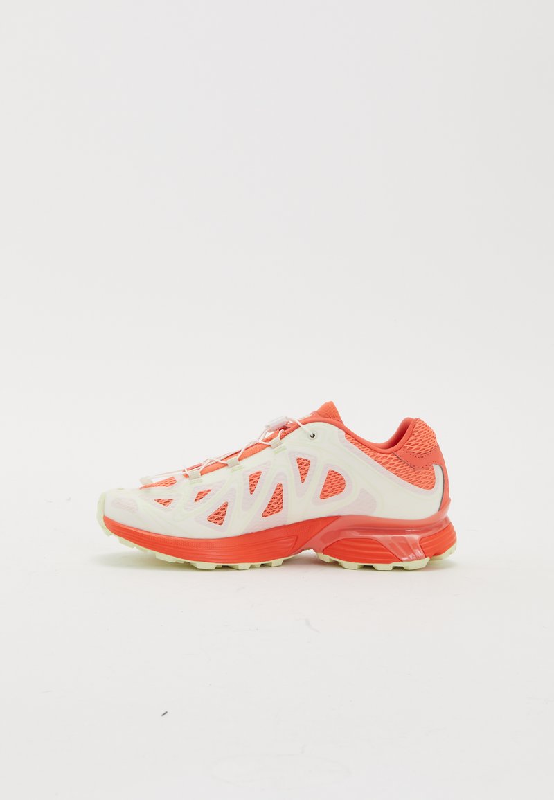 Lightweight athletic shoe with a white and coral design, mesh upper for breathability, rubber sole, and reflective accents on the heel.