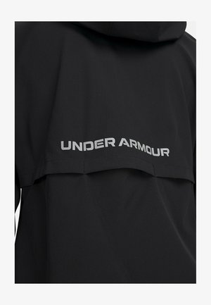 Zwarte sportjack met capuchon, gemaakt van gestructureerde stof, met zilveren "UNDER ARMOUR" branding langs de achterkant.