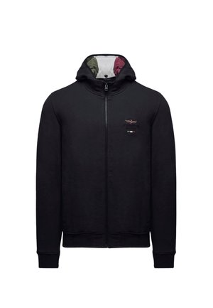 Felpa con cappuccio nera con zip, realizzata in tessuto morbido, con collo alto, polsini a costine e logo ricamato sul petto a sinistra. Fodera interna colorata.