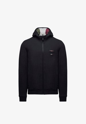 Felpa con cappuccio nera con zip, realizzata in tessuto morbido, con collo alto, polsini a costine e logo ricamato sul petto a sinistra. Fodera interna colorata.