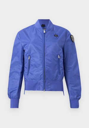 Blue bomber jacket with front zipper, zippered side pockets, ribbed cuffs and hem, and a patch on the upper left sleeve.