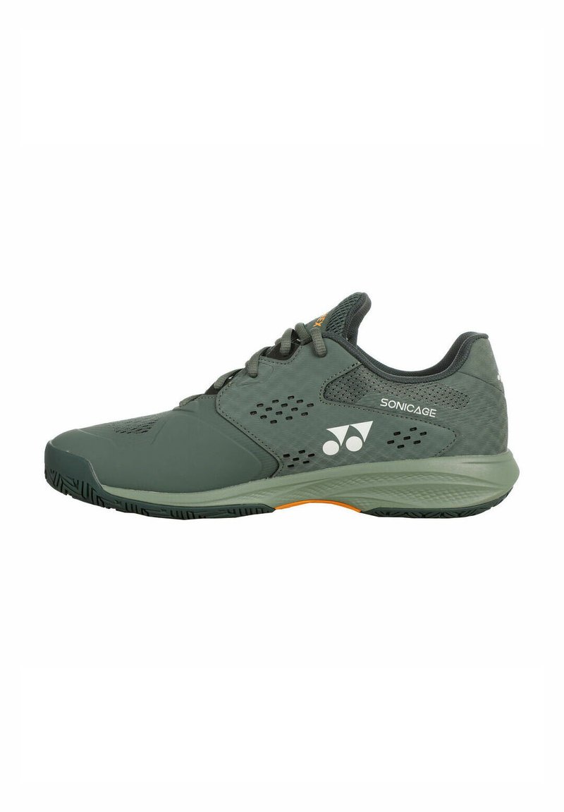 Green athletic shoe with a smooth upper, ventilated side panels, and durable rubber sole featuring an orange accent in the heel area.