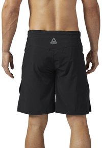 Svarta atletiska shorts tillverkade av lättviktig tyg, med en slät yta, elastisk midja och en liten Reebok-logotyp på baksidan.