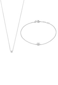 Silver necklace and bracelet featuring a small diamond-like accent. The necklace has a fine chain; the bracelet is slightly broader with a clasp.