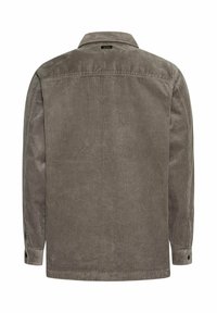 Bruine corduroy langwerpige overhemd met knoopmanchetten en een klein zwart label vlakbij de achterste kraag.