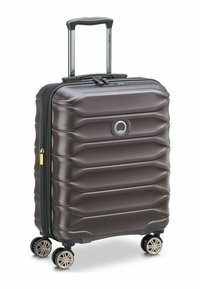 Hartschalenkoffer in Braun mit strukturiertem Design, ausziehbarem Griff, doppelten Reißverschlüssen und vier Rollen zum Drehen. Besitzt ein Logo auf der Vorderseite.