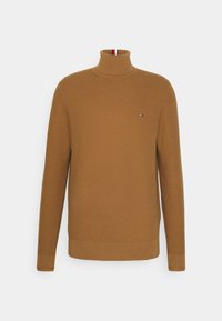 Maglione a collo alto lavorato a maglia marrone con polsini e orlo a coste. Presenta un piccolo logo sul petto. Materiale resistente con una finitura testurizzata.