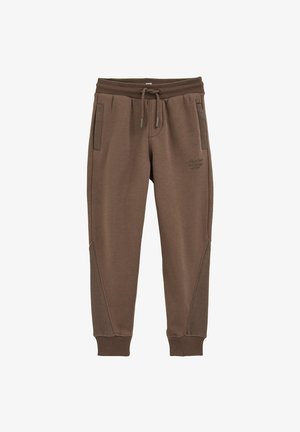 Hnědé tepláky se stahovací šňůrkou v pase, dvěma bočními kapsami a texturovanými doplňky na spodních částech nohavic. Bavlněná směs tkaniny.