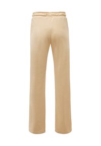 Béžové tepláky širokého střihu se soft povrchem, elastickým pasem a bez viditelných kapes. Navrženy pro pohodlný střih.