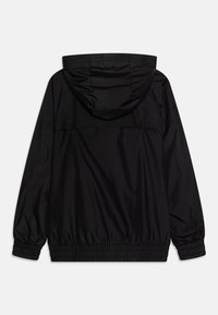 Black, lightweight jacket with a hood. Features elastic cuffs and hem, sleek texture, and a minimalist design without visible hardware.
