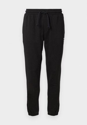 Zwarte sweatpants van een zacht materiaal met een elastische tailleband en koordjes, met taps toelopende broekspijpen en een subtiele logo-detail aan de zijkant.
