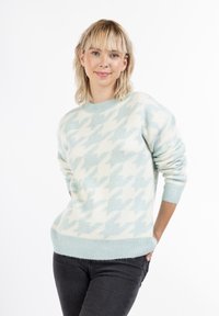 Helles blaues Sweatshirt mit weißem Hahnentrittmuster, Rundhalsausschnitt und gerippten Bündchen und Saum. Der Stoff wirkt weich und hat eine gemütliche Textur.