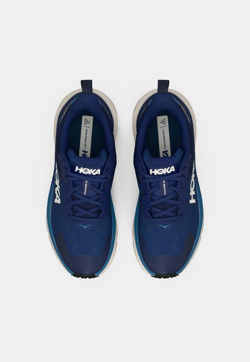 Blue lightweight athletic shoes with mesh upper, featuring a rounded toe, padded collar, and rubber outsole. "HOKA" logo prominently displayed.