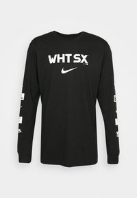 Czarna koszulka z długim rękawem z białym napisem "WHT SX", logo Nike na przodzie, oraz dodatkowymi białymi logo i tekstem na rękawach.
