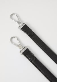 Black leather straps with a pebbled texture and chrome hardware, featuring snap hooks for secure attachment at both ends.