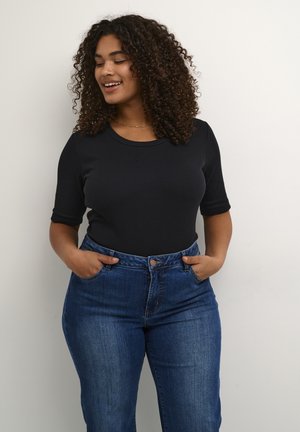 Black ribbed short-sleeve top paired with high-waisted blue jeans. The fabric is smooth, and the style features a round neckline and relaxed fit.