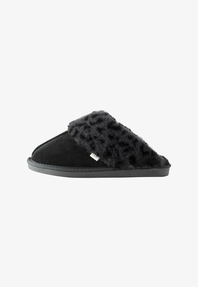 Black slipper with a faux fur upper, soft texture, and a solid black suede base. Features a flat rubber sole and subtle stitching details.
