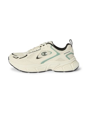 Zapatilla deportiva de color crema con detalles en negro y verde, paneles de malla, suela gruesa y logo de Champion en el lateral.