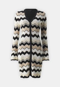 Cardigan en maille à col en V, présentant un motif en zigzag noir, beige et crème. Il dispose de manches longues et d'une fermeture à boutons sur le devant.