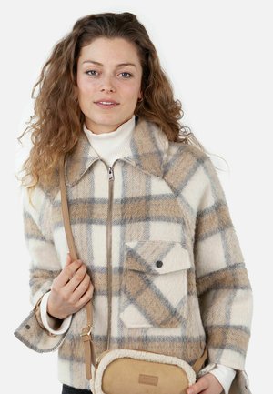 Checked wool jacket in cream, beige, and grey; features a zippered front, pointed collar, and front pocket. Paired with a beige crossbody bag.