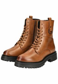 Bottines en cuir marron avec bout rond, laçage sur le devant, fermeture éclair sur le côté, semelle en caoutchouc noir et tirant à l'arrière pour un enfilage facile.