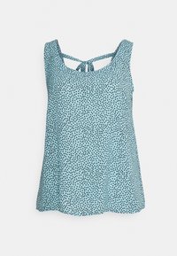 Top senza maniche di colore azzurro chiaro con pois neri, scollatura rotonda e dettagli con fiocco sul retro. Tessuto morbido e fluido.