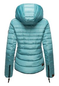 Doudoune bleu clair avec capuche, design matelassé et zips apparents au niveau des poignets. Comprend un écusson logo sur la manche gauche.