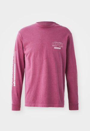Long-sleeve, burgundy cotton t-shirt featuring "OBEY" logo on the chest and text graphics on the sleeves in white. Relaxed fit with crew neckline.