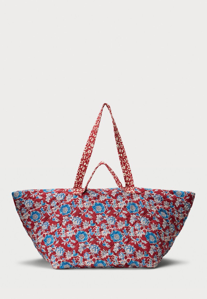 Large quilted tote bag with red background and blue and white floral pattern, featuring two sets of fabric handles.