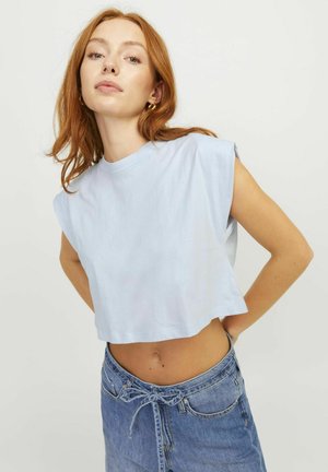 Camiseta corta azul claro con cuello redondo y mangas cortas caídas, combinada con una falda de mezclilla de cintura alta que presenta un detalle de lazo.