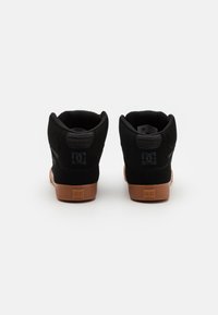 Black high-top sneakers with a suede and synthetic upper, rubber sole, and logo detail on the heel and tongue. Brown outsole.