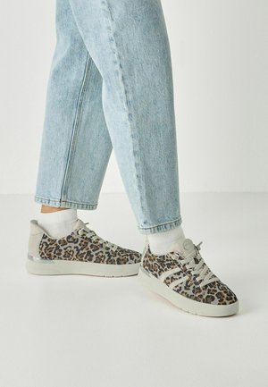Leopard print sneakers with grey accents, featuring a textured surface, lace-up design, and white socks, paired with light blue jeans.