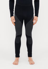 Zwarte sportlegging met een getailleerd ontwerp, voorzien van textuurelementen en een soepele tailleband. Gemaakt van rekbare stof.