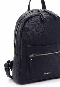 Navy blue textured leather backpack with front zip pocket, double zipper main compartment, adjustable strap, and top handle.