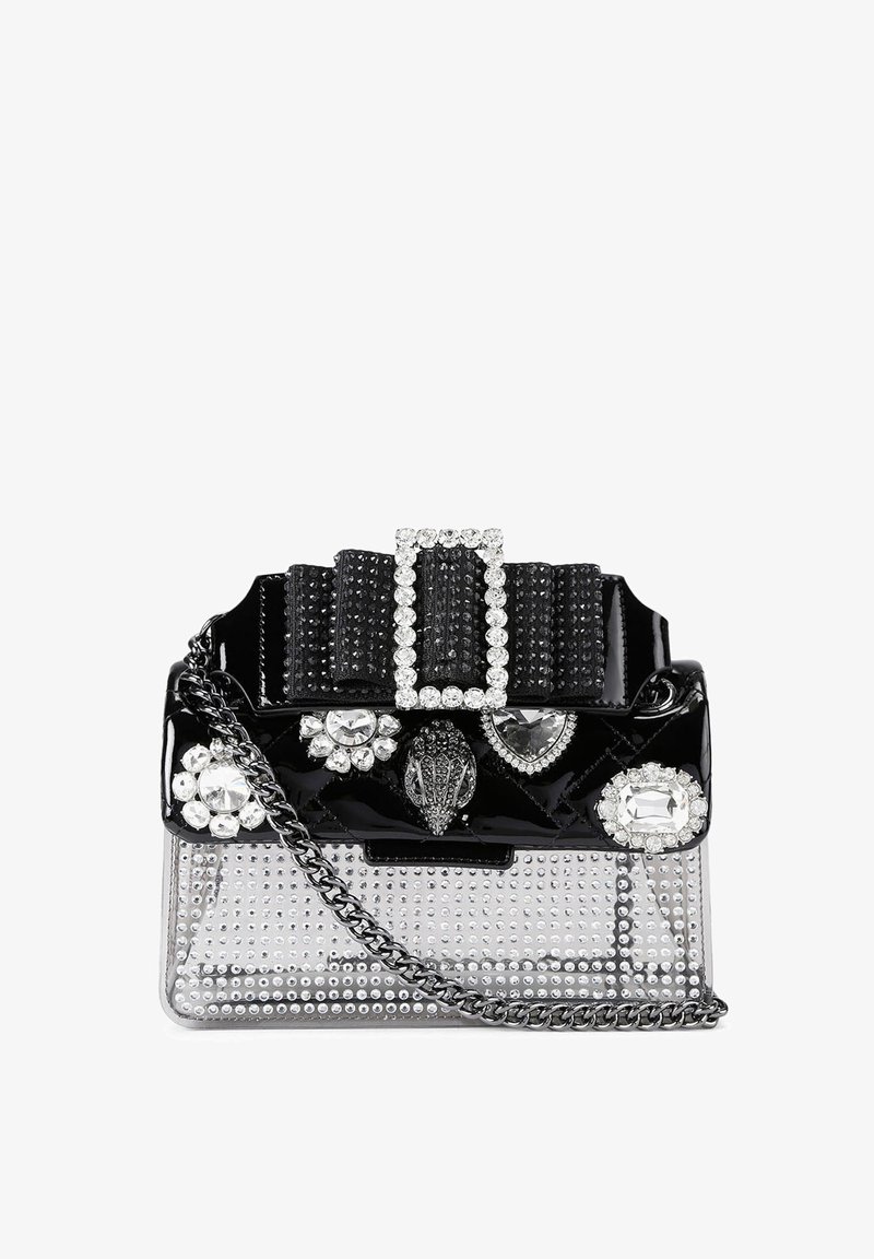 Black patent leather handbag with a transparent bottom, embellished with rhinestones and a jeweled buckle on top. Features a chain strap.