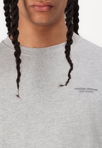 Grey cotton crewneck sweatshirt featuring a small embroidered logo with "WEEKEND OFFENDER" and "ADMIT NOTHING" in a matching color.