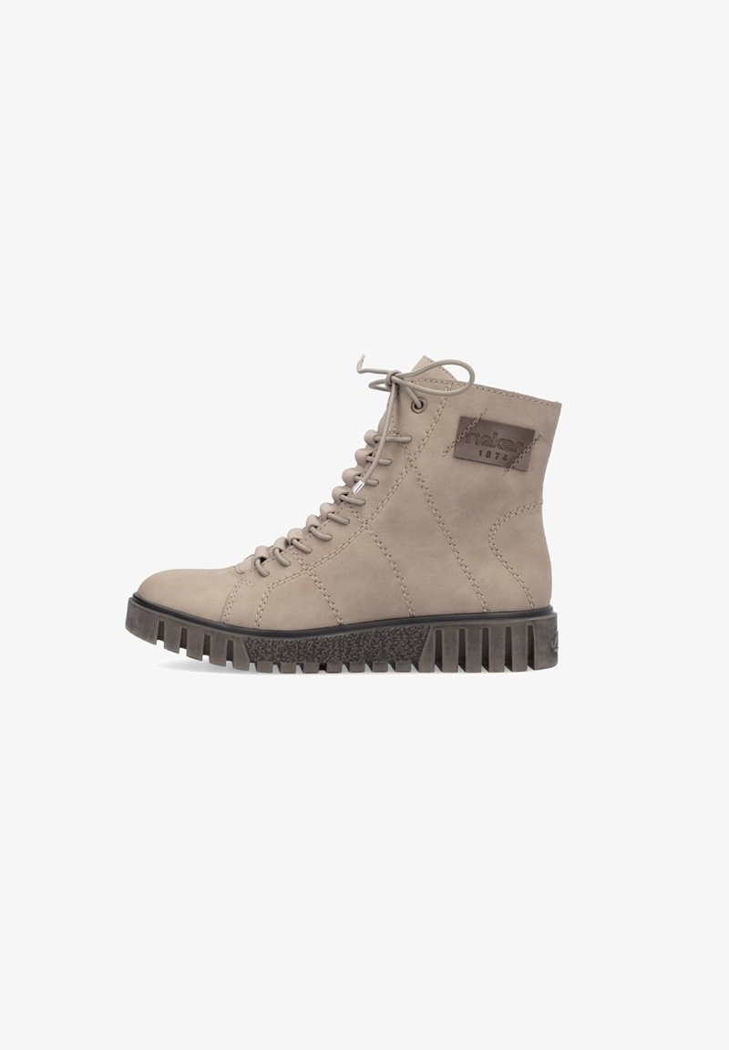 Botte beige en daim à tige haute avec des lacets ronds, une semelle en caoutchouc texturée et un design cousu. Comprend un écusson logo sur le côté.
